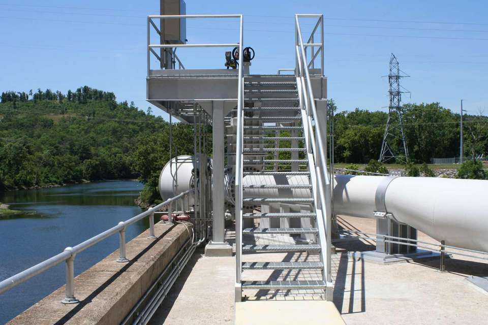 Siphon provides minimum flow through dam, benefits fish habitat